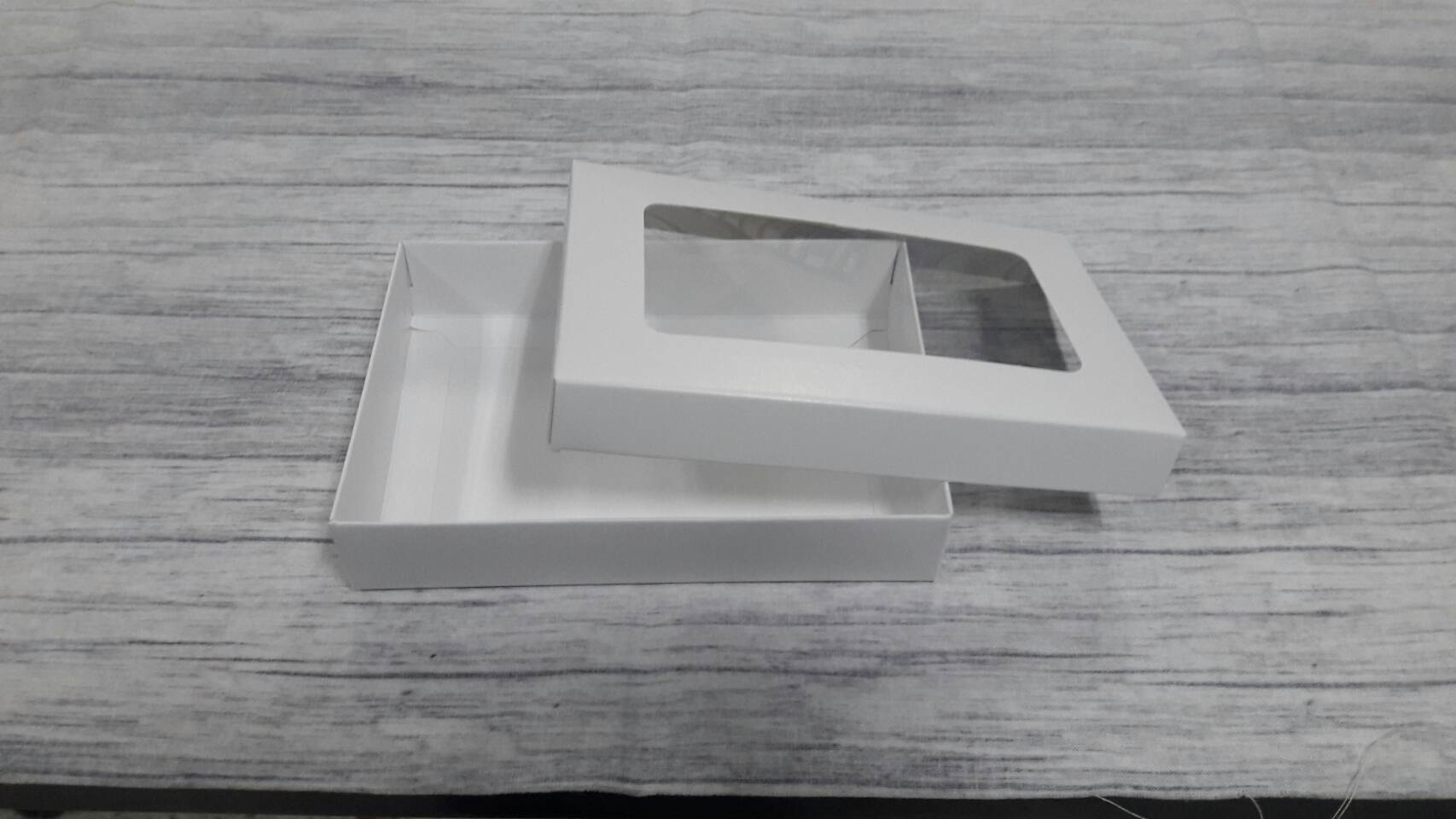 กล่องฝาครอบ กล่องของขวัญ กล่องแบบมีฝาครอบ กล่องอเนกประสงค์ ขนาด 10 x 15 x 3 ซม. สีขาว แบบมีหน้าต่างพลาสติก ราคา 265 บาท ต่อแพ็ค (20 ใบ)